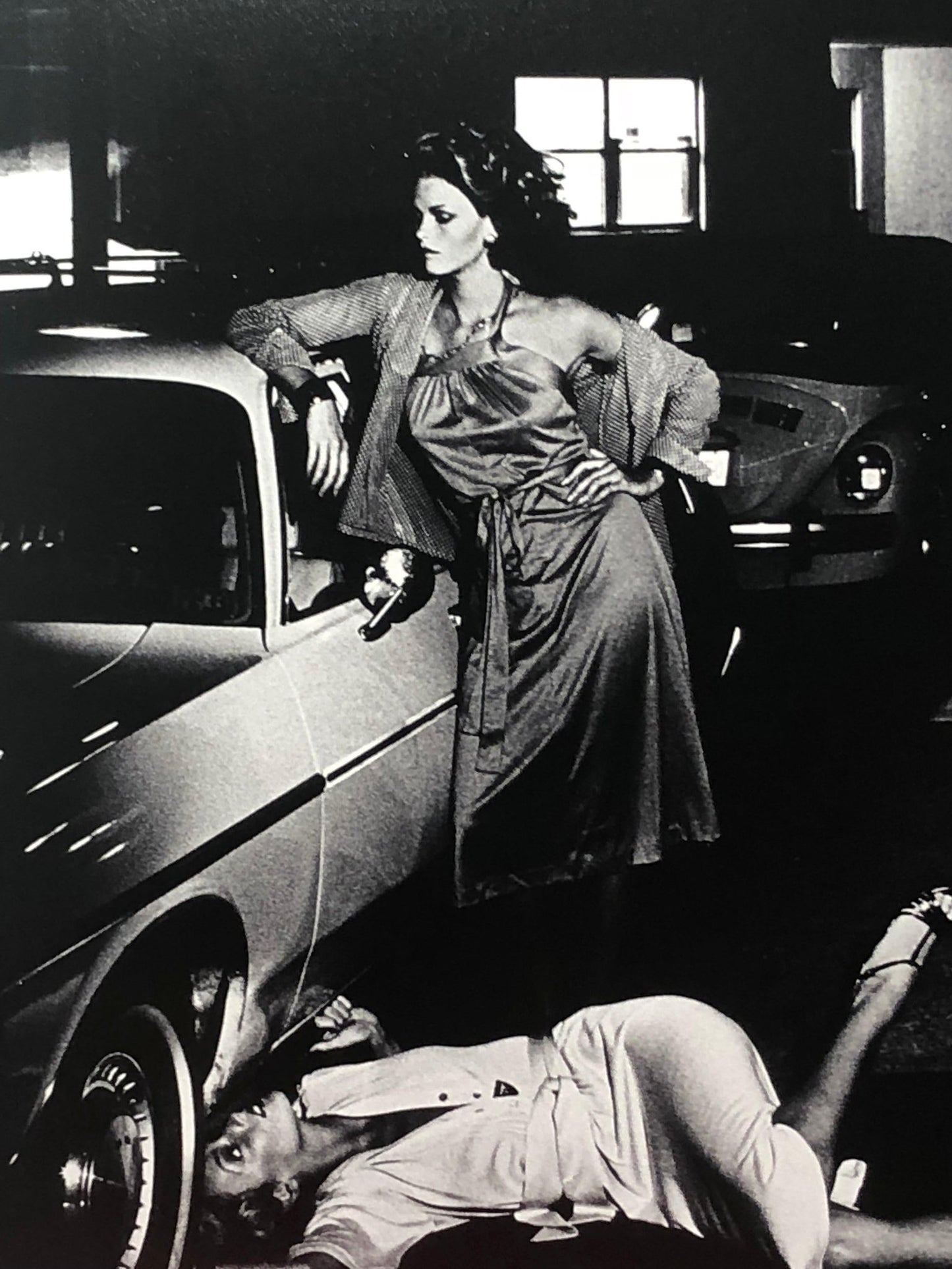 Models Inspecting Brake Lining by Helmut Newton